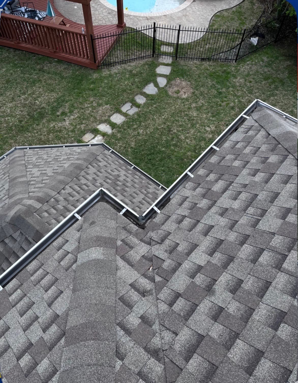 Clean gutters running along a residential roofline after service